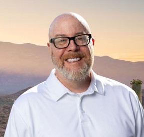 Portrait of Kenneth King with mountains in the background