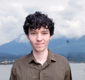 Portrait of Travis “TJ” Bracegirdle with mountains in the background