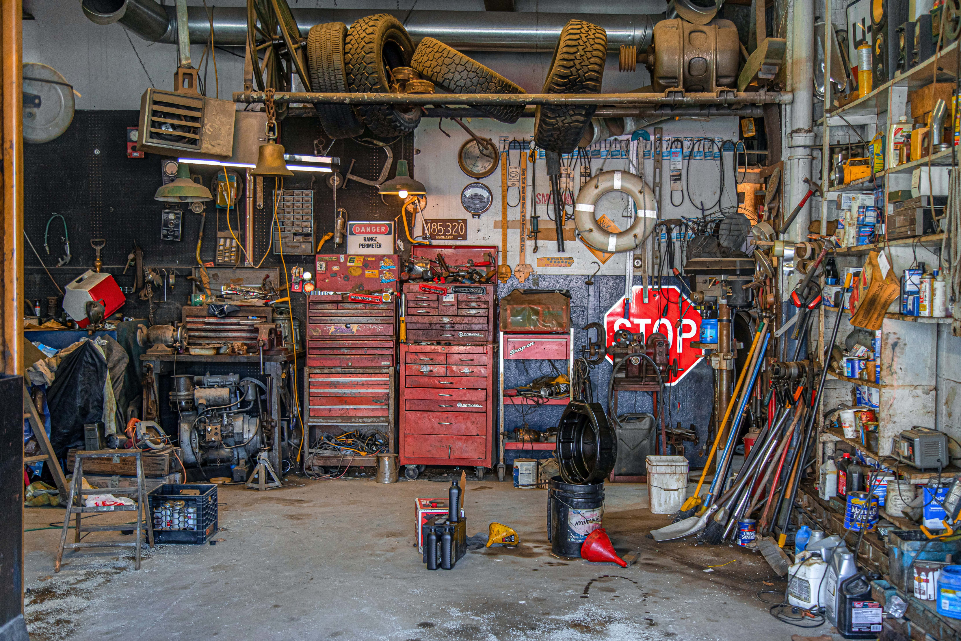 A well-used mechanic's stop with every tool, tire and hose and clamp, but no car